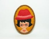 A girl with a red hat felt brooch