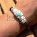 dark brown leather bracelet with turquoise spacer bead and sterling silver plated findings