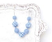 Light blue necklace with crocheted and fabric beads