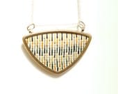 silver geometric triangle necklace // cross stitched x // white orange yellow green grey modern