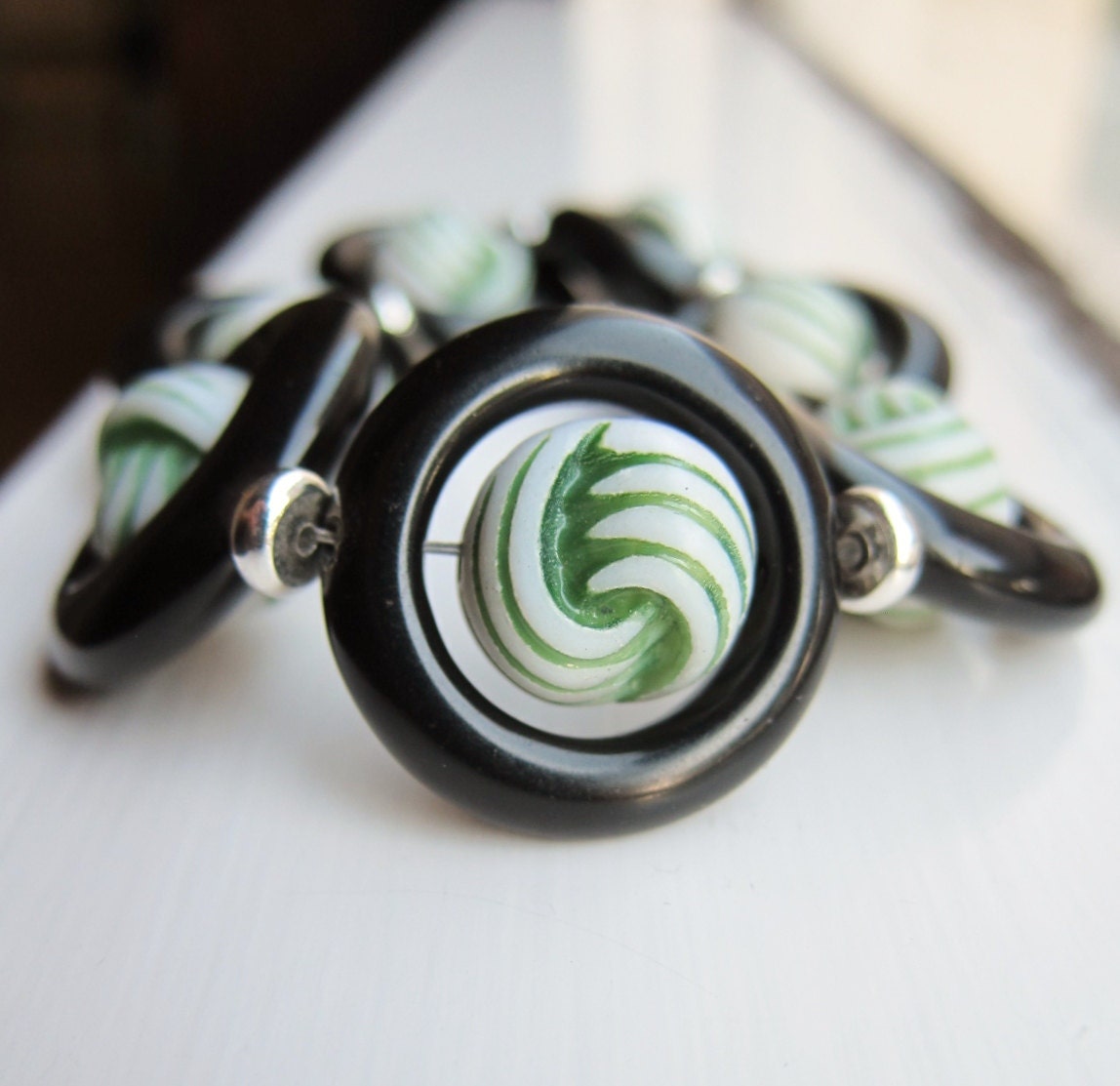 Green, white and black circular bracelet - textured vintage lucite beads