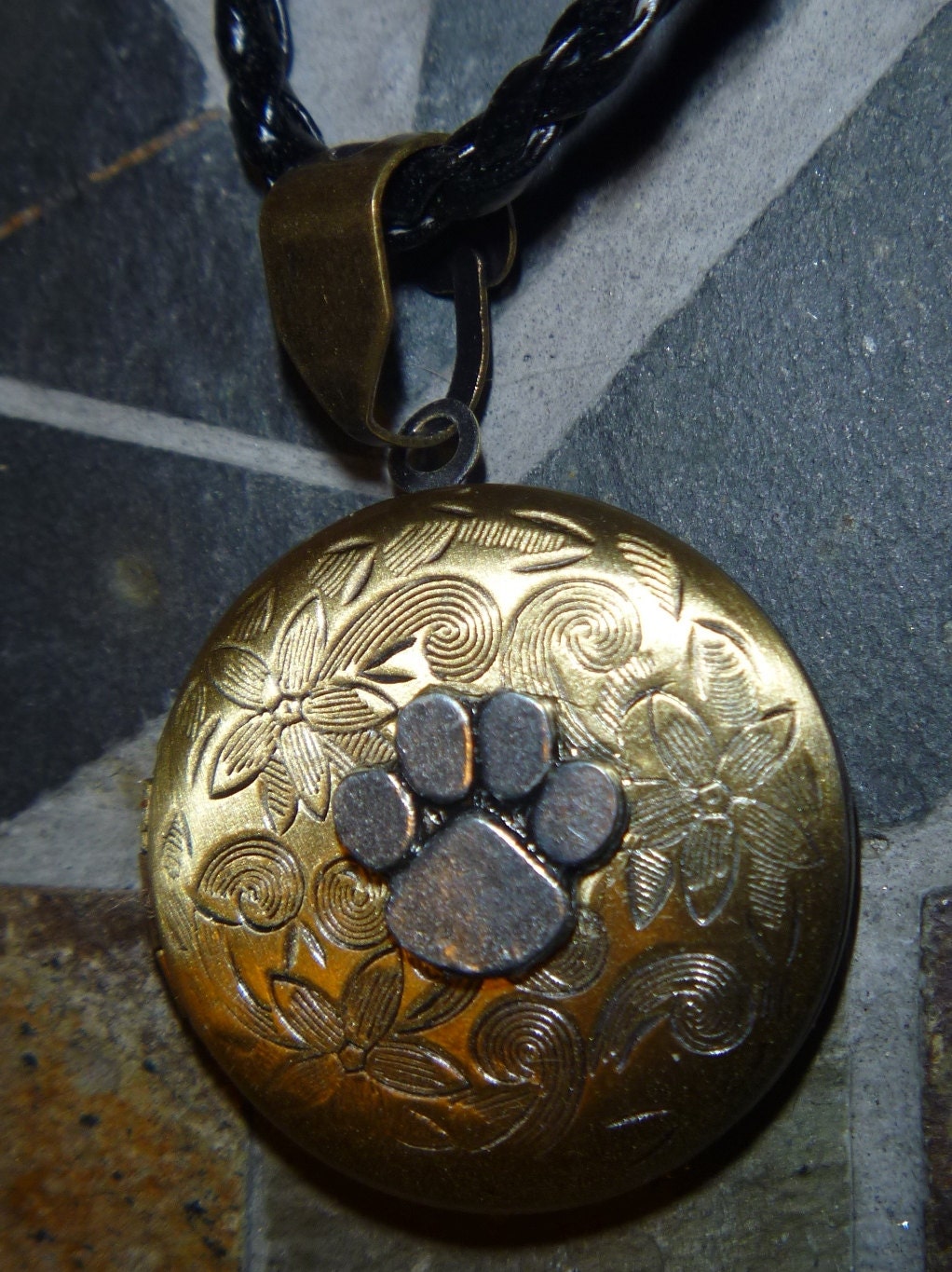 Paw print round floral locket with black cord