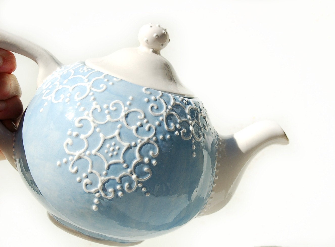 Blue teapot detailed with white accent