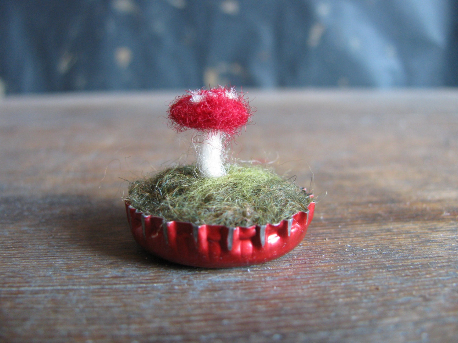 Felted amanita mushroom in a metallic red bottlecap