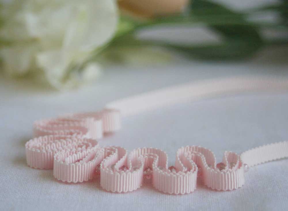 Delicate pastel pink grosgrain ribbon with pearls and crystals.