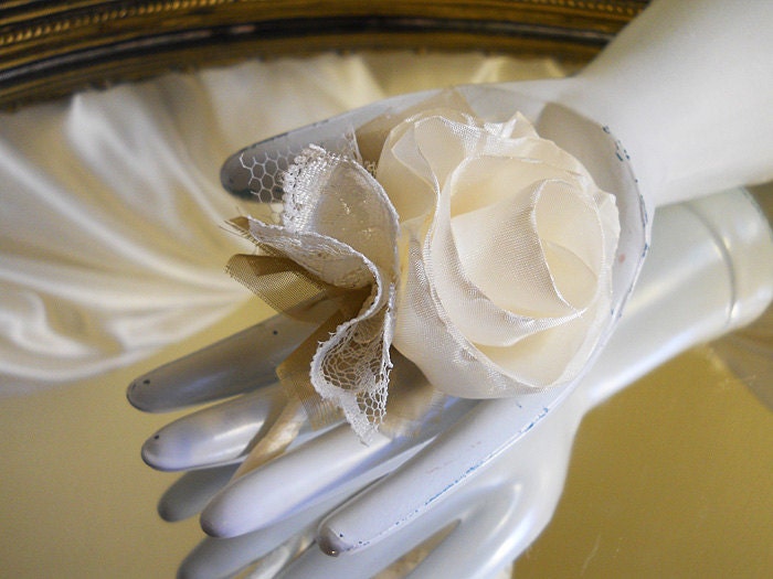 Ivory Rose Pin on Boutonnieres, order as many as you need. I can have them done for you in one week.