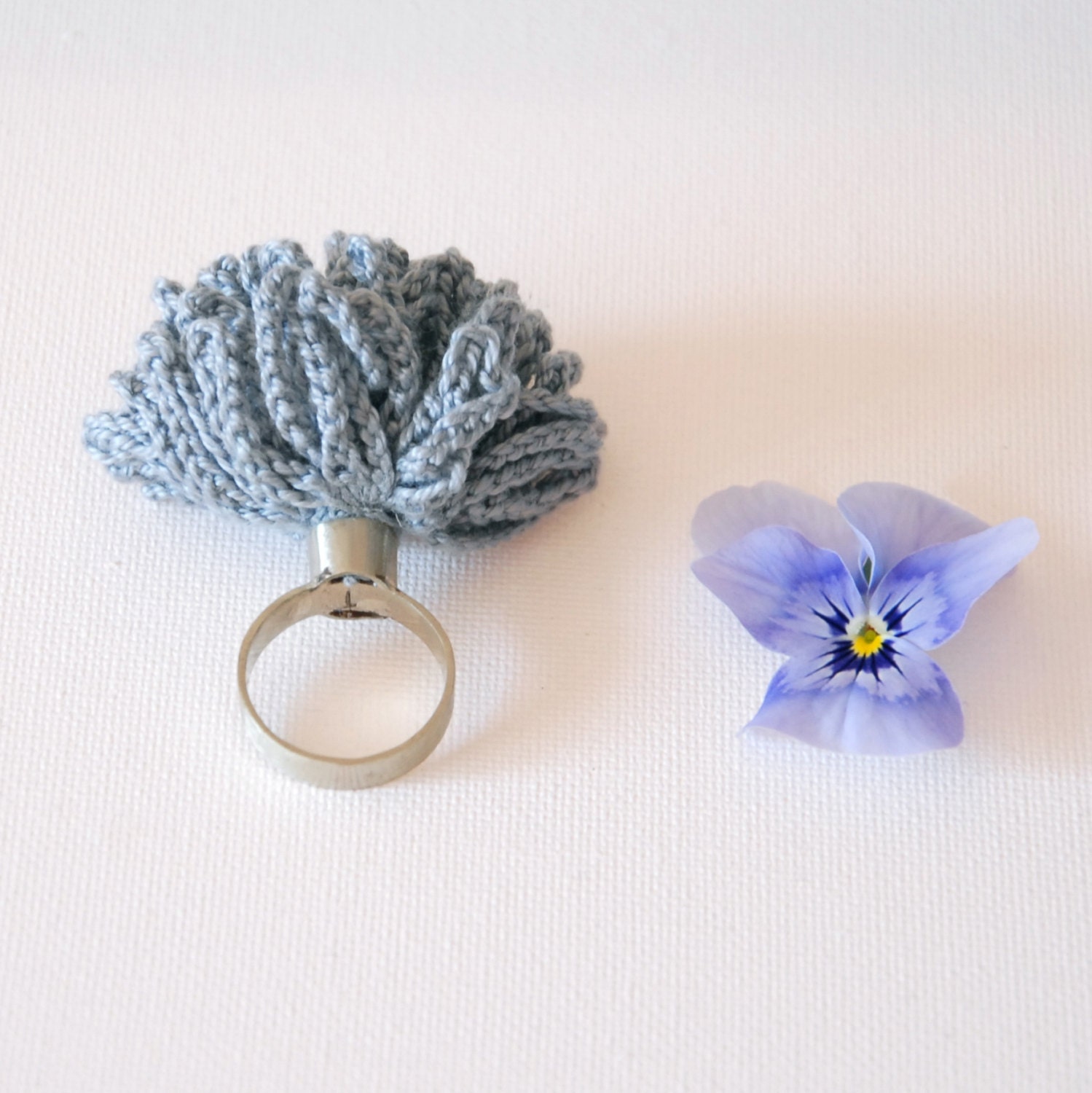 alpaca metal ring with crochet flower in grey