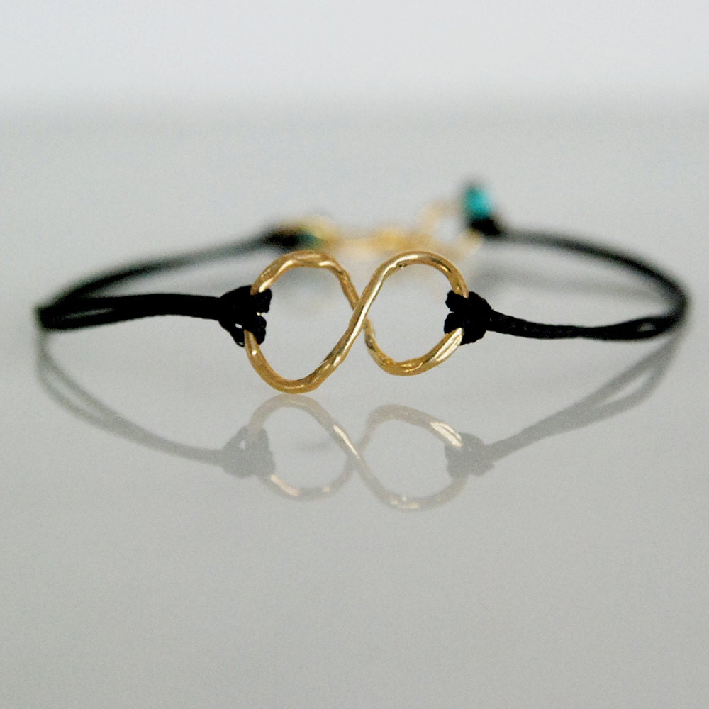 Gold infinity symbol bracelet with black cord