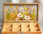 Wooden tea box with flower meadow embroidery.