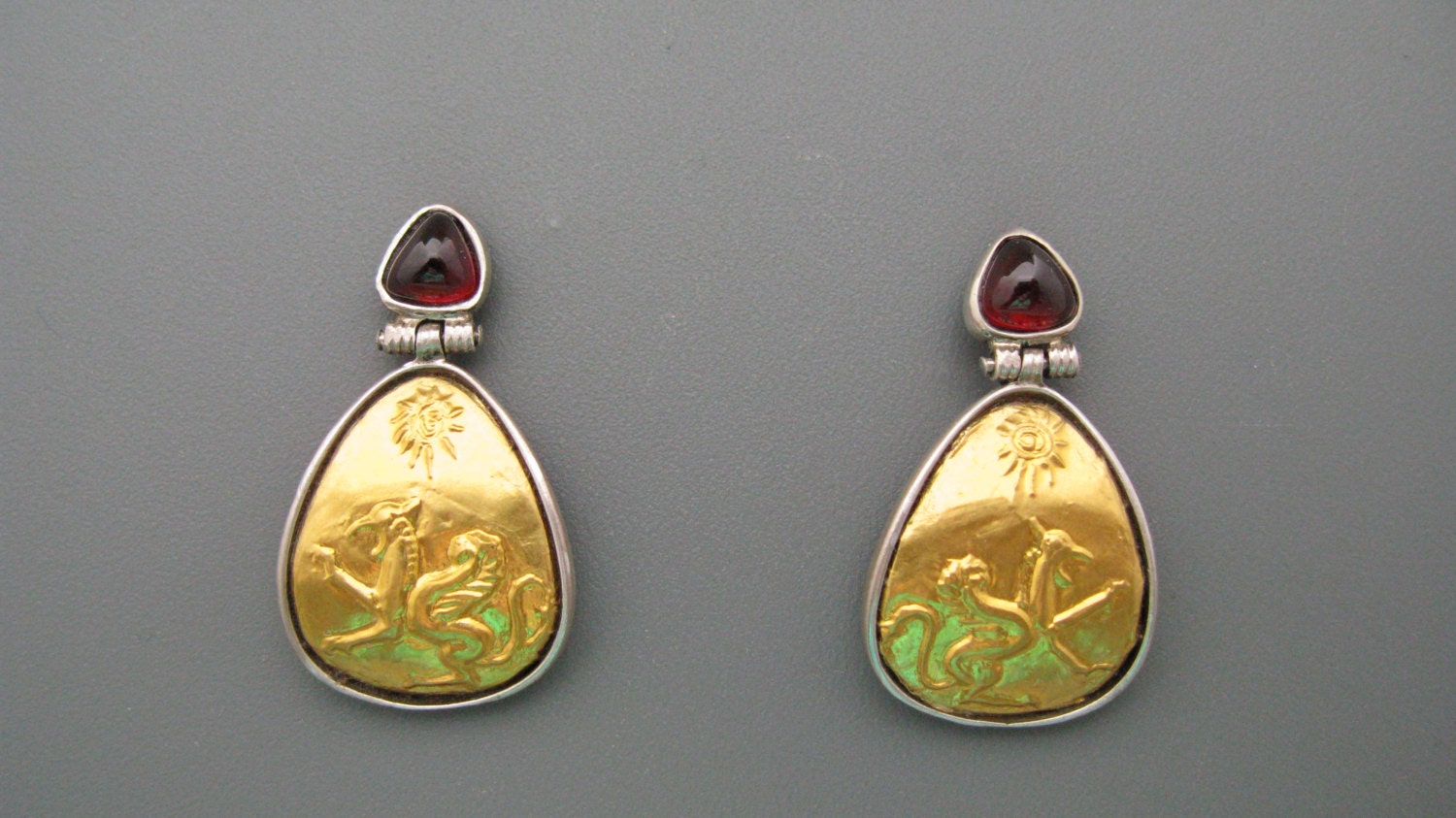 Griffins - earrings of pure gold repoussee on silver with custom cut garnets