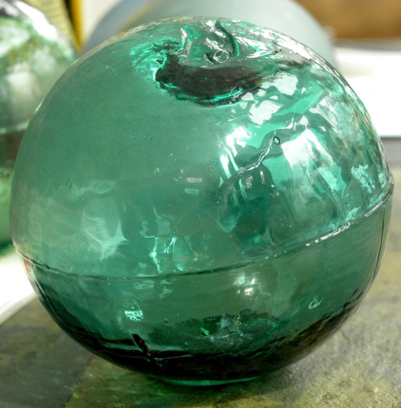 Glass antique fishing float from Alaska in teal, partial frost, nice net marks with Kanji