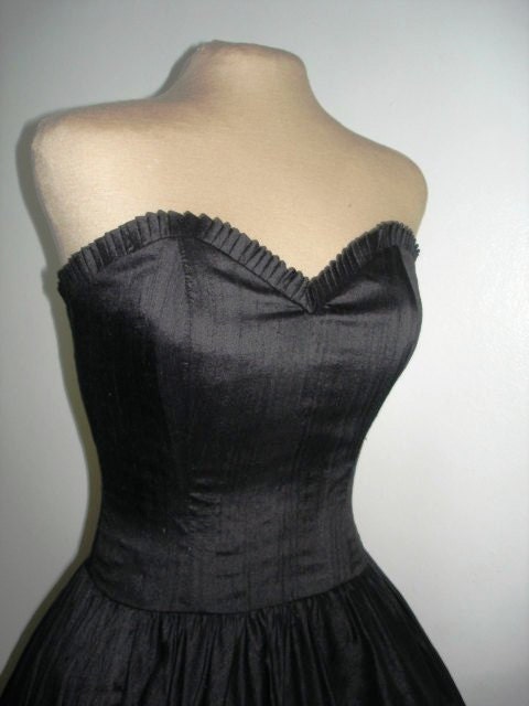 A supremely sexy and simple 50s inspired cocktail dress made from black duchess satin. Have it perfectly made to measure. Any size welcome