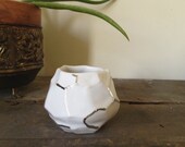 white and silver faceted vessel