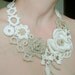 Ivory and light beige flowers crochet necklace .