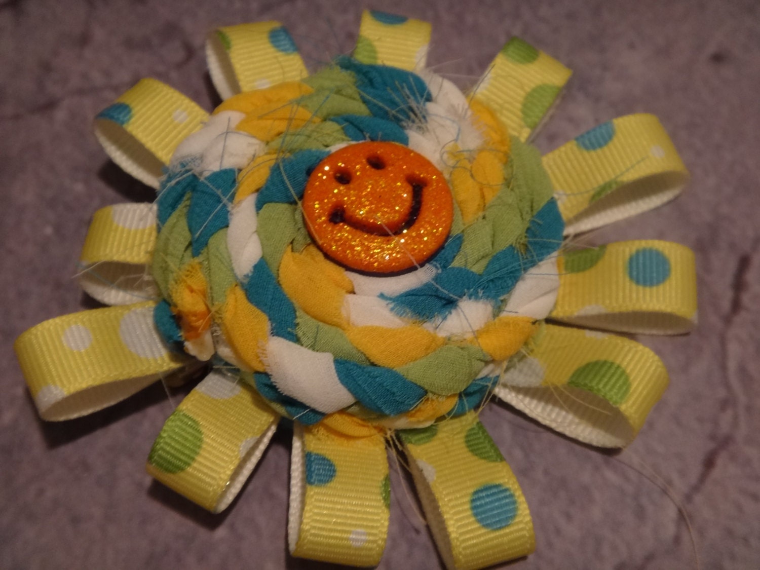 Yellow & Blue Braided Chiffon Rosette Hair Bow Surrounded By Yellow Polka Dot Ribbon Loops with Bright Orange Smiley Accent