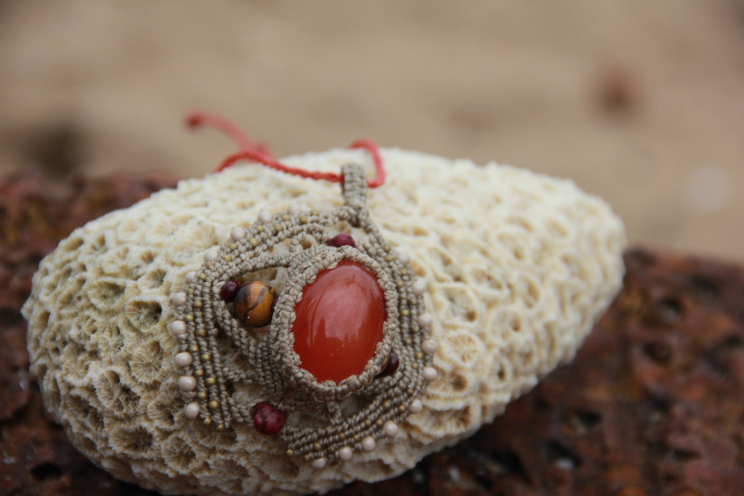 macrame pendant with carnelian, howlit, tiger eye, glass and brass beads