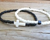 White cross and black cube bracelet duo