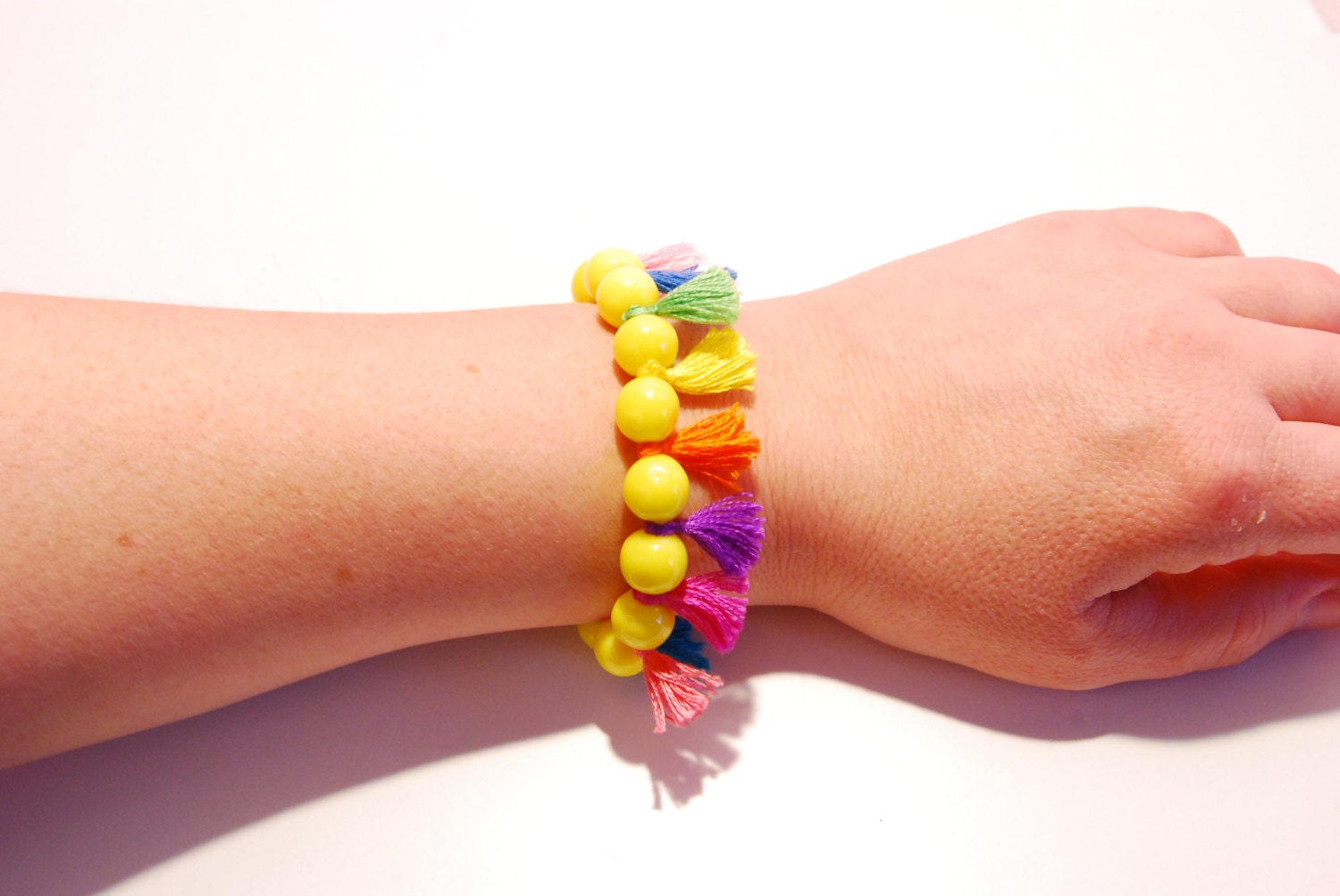 Neon Yellow playful bracelet with colorful tufts made from handmade polymer clay beads