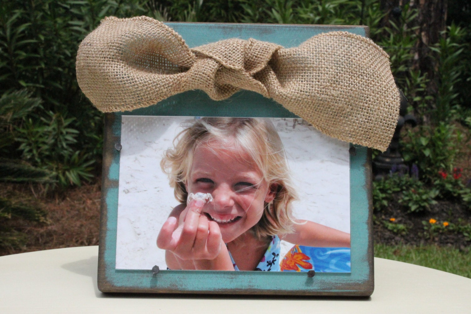 Blue Distressed Wooden Frame with a Natural Burlap Bow