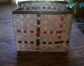 This basket is made of up-cycled magazine pages. Woven and glued, then hand sewn sides and bottom.