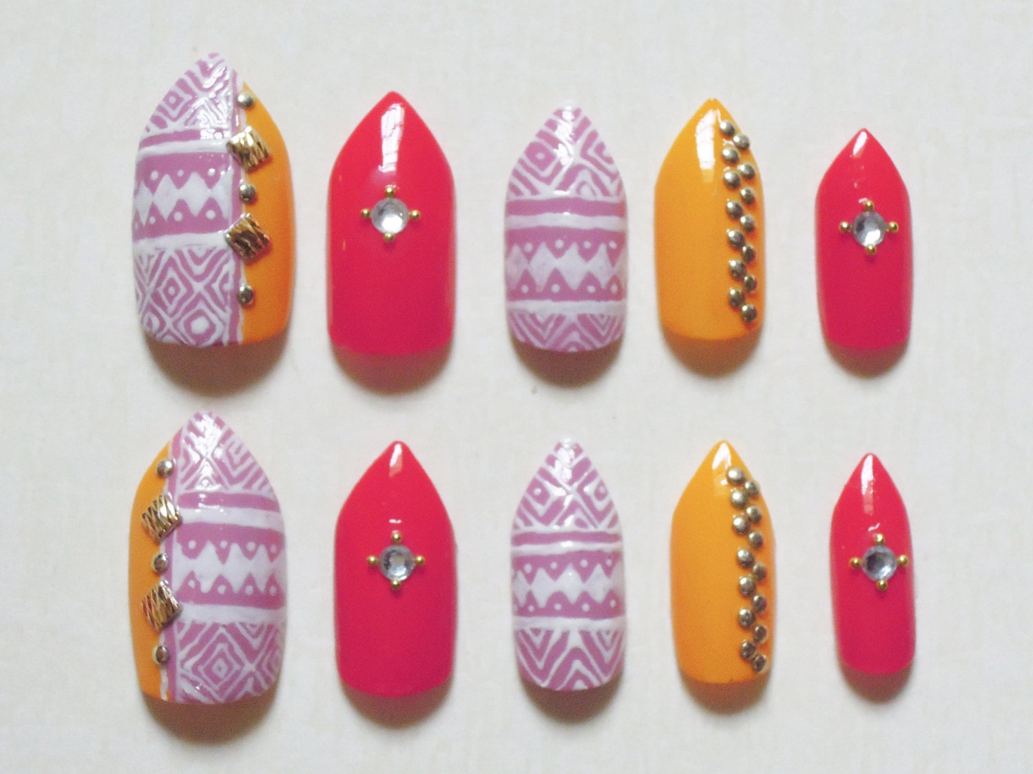 Pink, Yellow and Coral Stiletto Fake Nails with Aztec / Tribal Print, Rhinestones, Gold Studs and Beads Nail Set