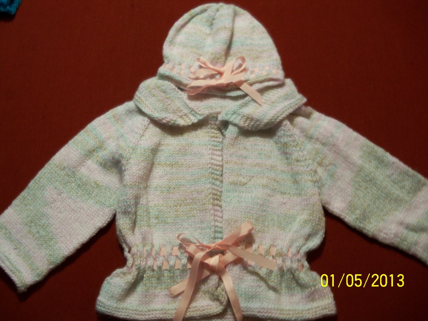 Beribboned sweater and hat. Made from soft baby yarn.