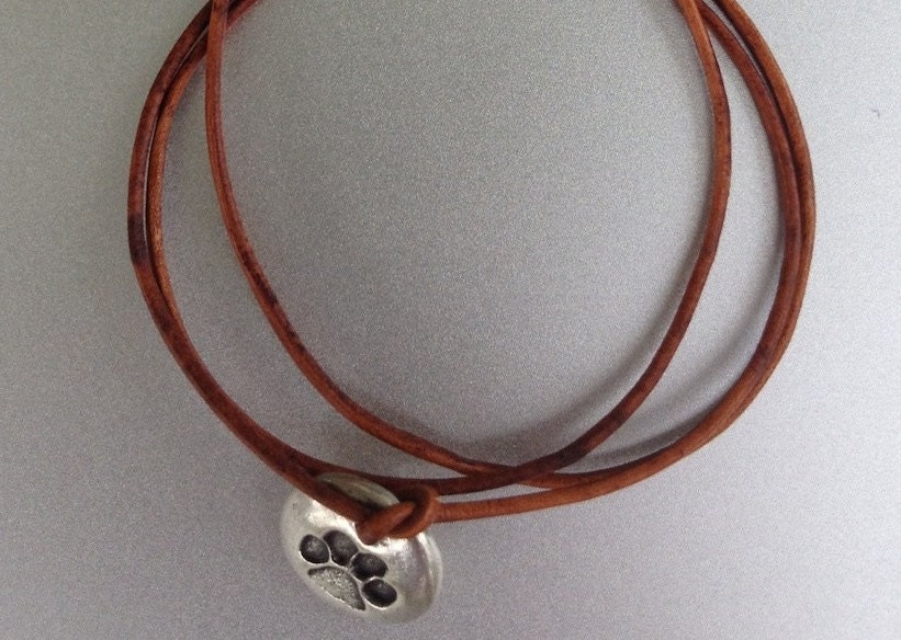 Leather triple wrap bracelet with dog paw charm. Wear it to show your support for animal rescue.