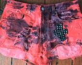 Red and blue tie dye Levis cutoffs with stud cross