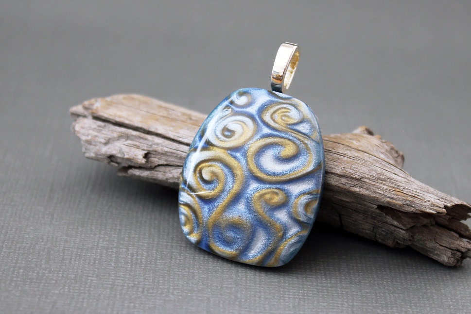 Polymer clay jewelry. Polymer clay pendant.  Glossy finish.  Funky. Blue gold swirls.