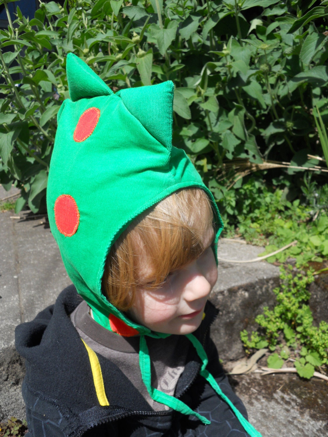 Green and orange polka dot dragon/dinosaur hood