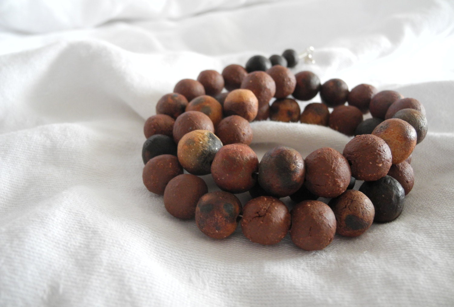Beaded necklace ethnic tribal with pit fired and ceramic beads in rust orange