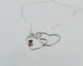Sterling Silver Eclipsed Hearts Pendant Necklace with Ruby Stone