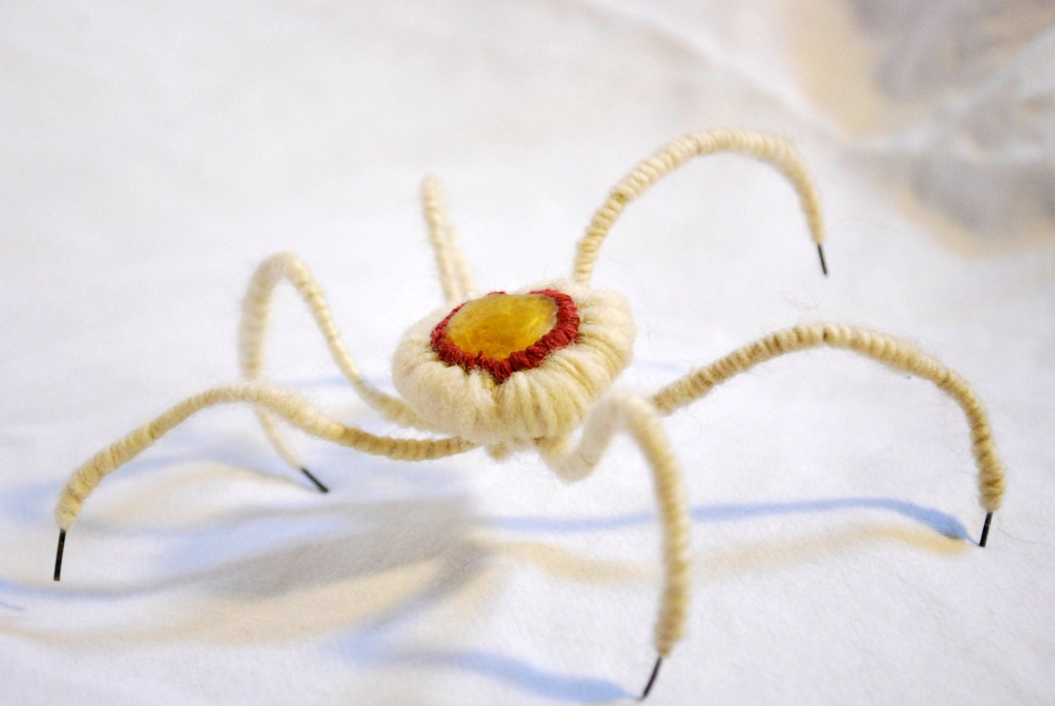 Small Disease Bug:  A white fiber sculpture of a wound on legs
