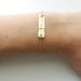 Hammered 14k gold monogrammed bracelet.