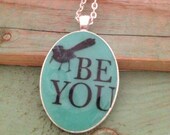 Aqua black bird 'be you' resin pendant necklace.  Large oval 30 x 40mm