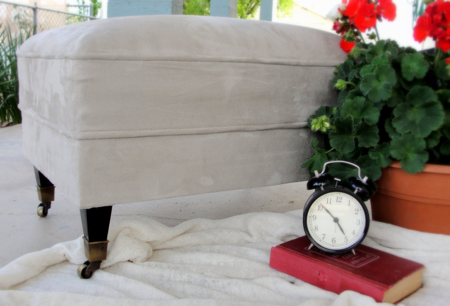 Mid Century ottoman - upholstered in gray suede - original casters