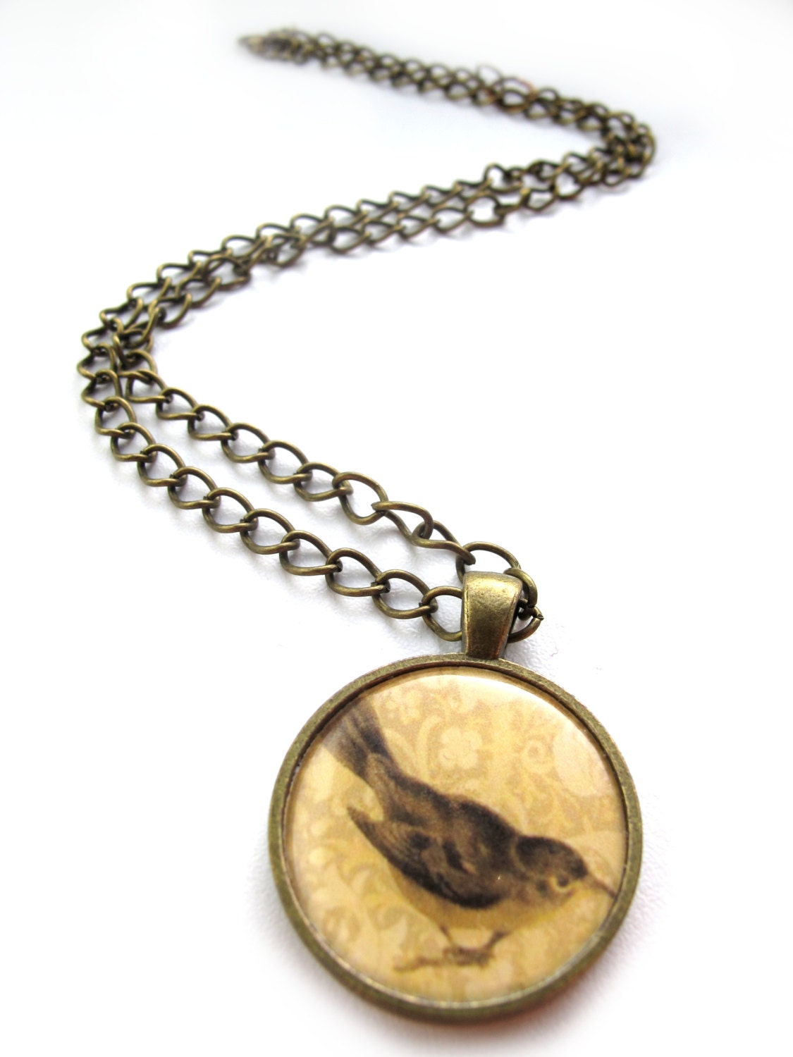Bird necklace - a cute sepia image of a bird on a brass pendant