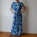 Slinky maxi dress, blue turquoise floral, viscose, cap sleeves, sash belt. One size fits many.