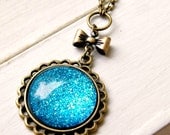 blue moon glitter sparkle glass pendant on antique brass chain