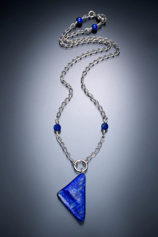 Handmade necklace with uniquely cut lapis pendant  on a sterling silver chain with small lapis accent beads and a lobster clasp