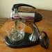 Sunbeam Mixmaster chrome with meat grinder attachment Bakelite base midcentury