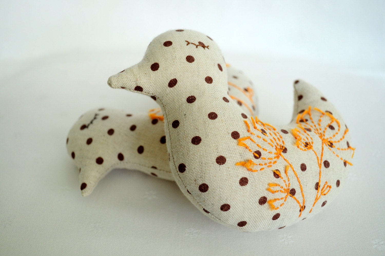 Two polka dot birds with orange flowers