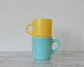mismatched pair yellow and turquoise glass mugs  fireking yellow mug