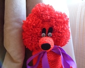 Valentino a warm red Gin Poodle with a black ribbon bow collar