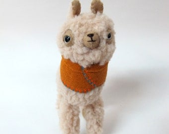 Small Wooly Alpaca in a Pumpkin-Coloured Embroidered Cape