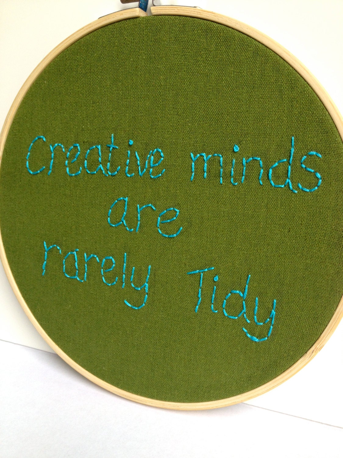 Embroidered Quote: creative minds are rarely tidy.  Embroidered hoop art.  Inspirational quote.