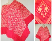 70s tribal tiki poncho, hot pink ethnic yarn print with full fringe hem.  Retro boho chic fuchsia pink, this poncho does it all.