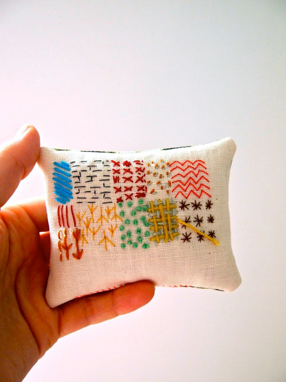 Hand embroidered display pillow with lavender abstract