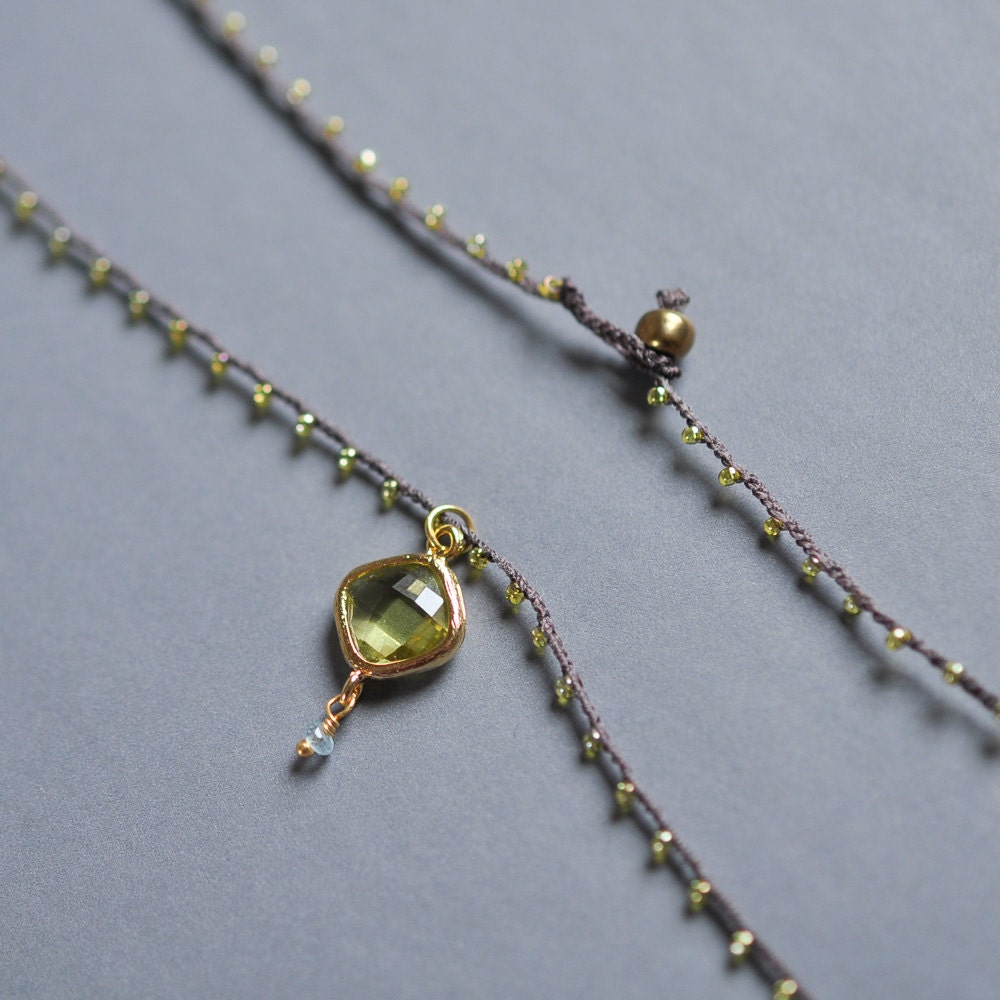 Gold and Peridot Green Dangle Charm with pale blue chalcedony drop on daintiest crocheted necklace in gold and brown