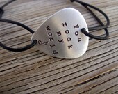 Hand stamped aluminum guitar pick bracelet stamped with you rock my world- leather cord- great unisex gift- adjustable